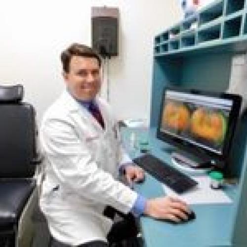 Dr. Ivan Suñer smiling at desk in office